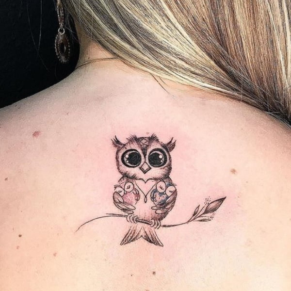 Búhos tatuados en espalda de chica